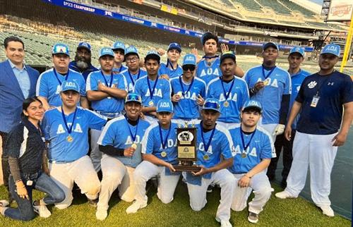 baseball team posing at the Tigers stadium after distict champions