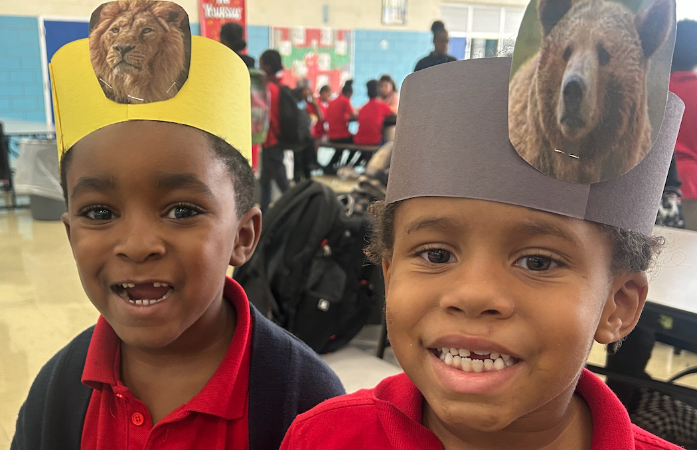 Two students with crowns featuring different animals