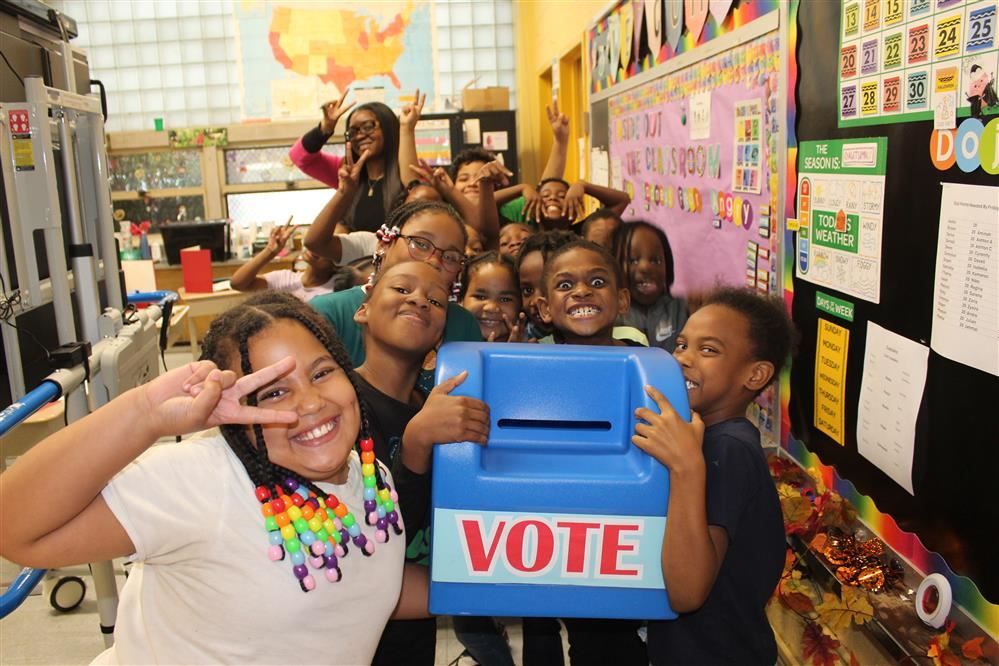  Students pose with voting booth