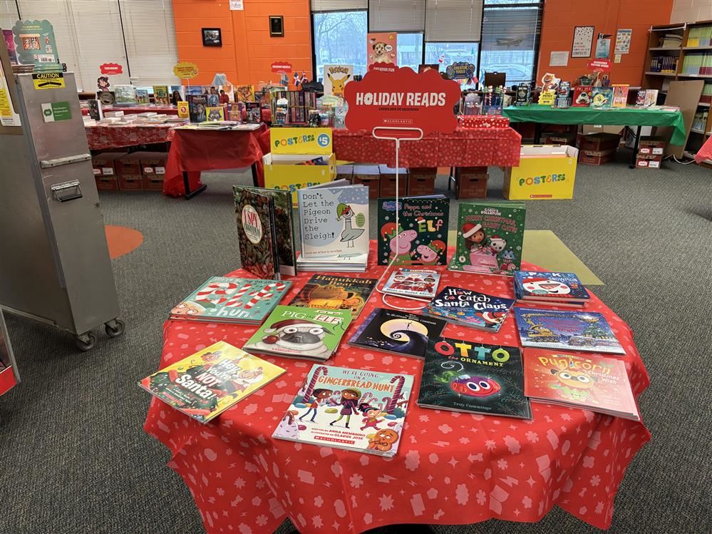  a red table cloth on a book with holiday picture books 