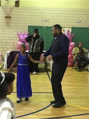 dad and daughter dancing in gym for daddy daughter dance 