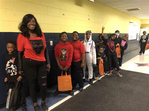 students with teacher on halloween  