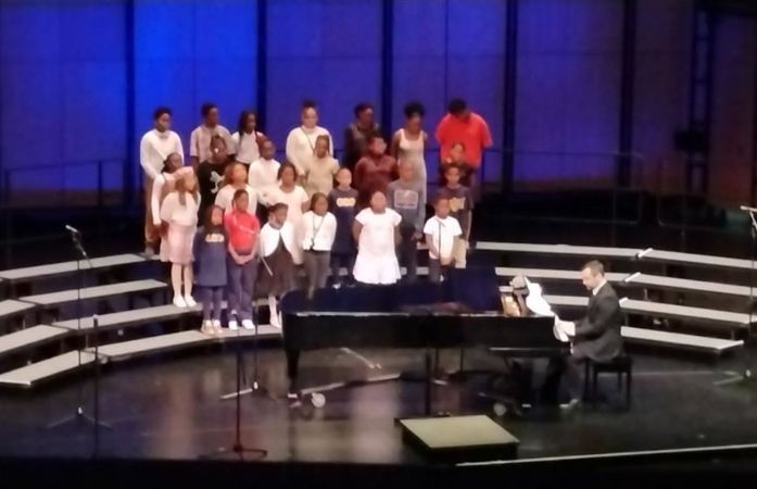   students singing on stage