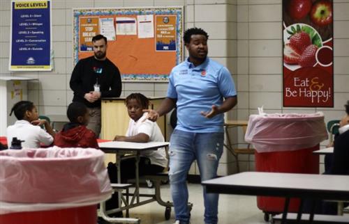 Teacher speaking to students