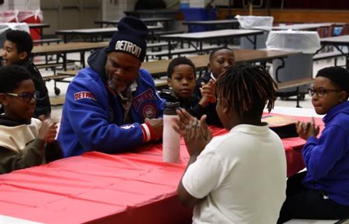 Students and a dad sitting at the table