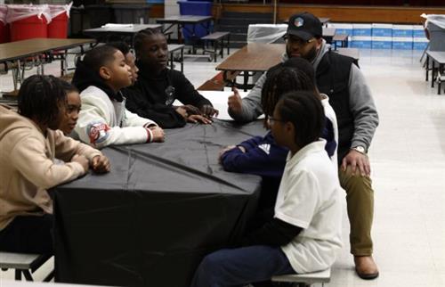  Students sitting at the lunch tables with dads 