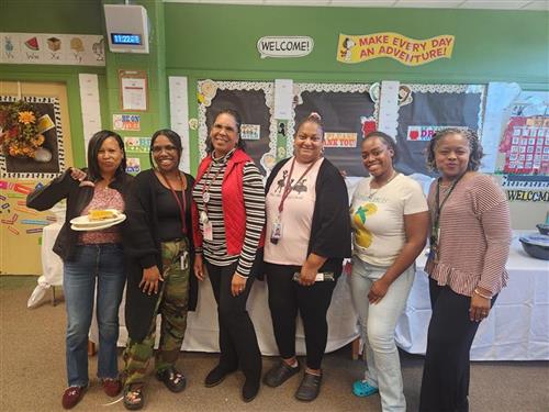 teachers posing in front of taco bar