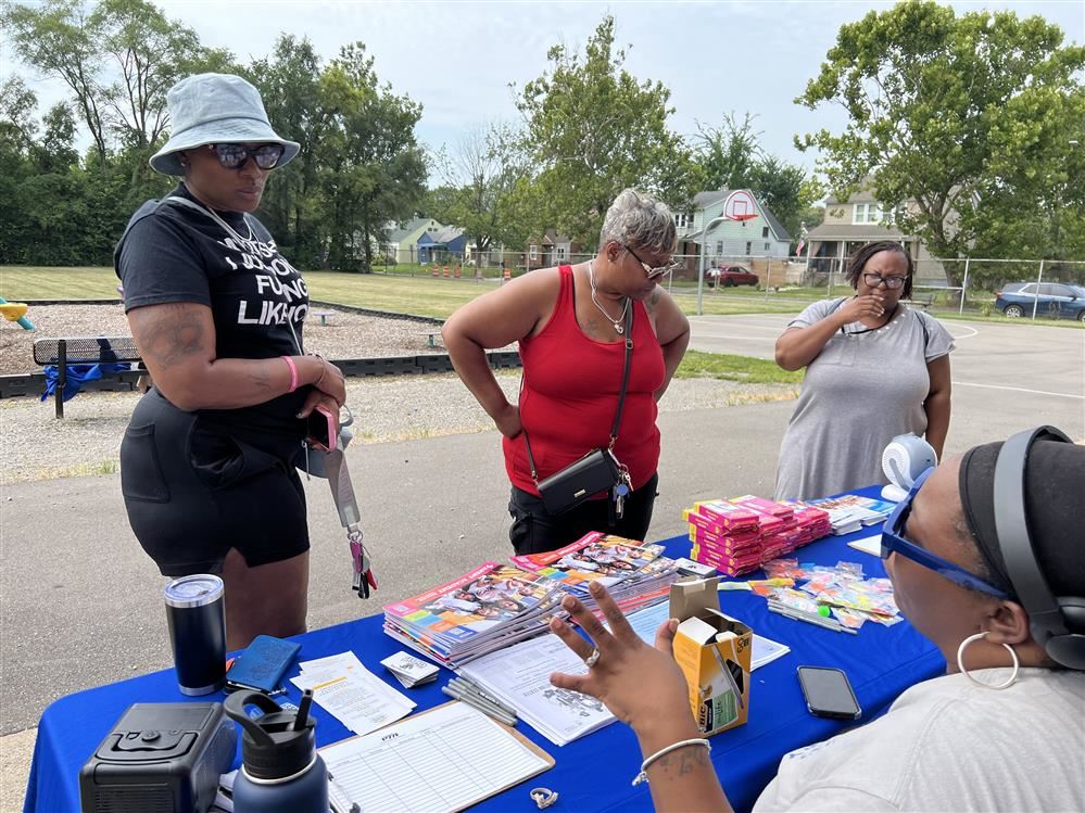  Parents standing at table with items for school