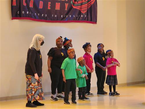Students singing with teacher