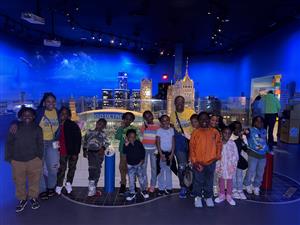  OST students pictured in front of ford field replica at legoland
