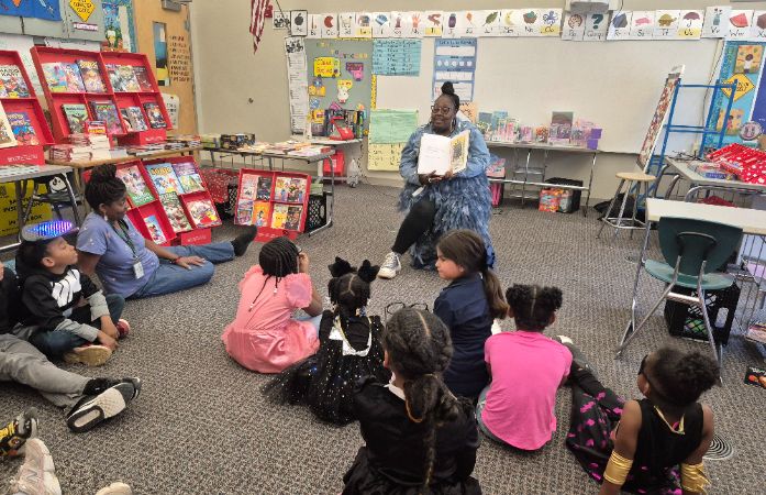  Teacher is reading to 2nd grade class