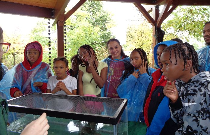  Teacher and her students outside in the rain