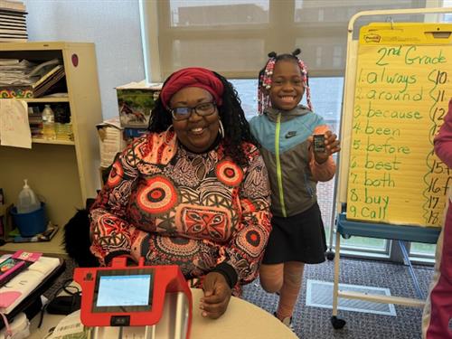 Student and teacher are smiling