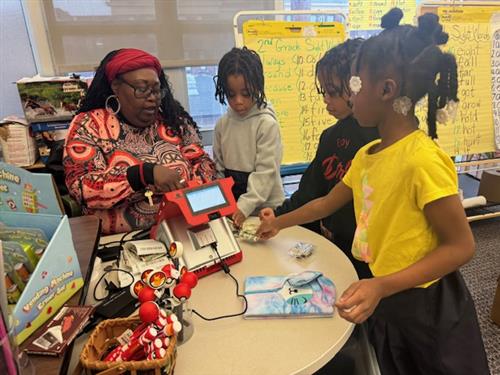 Students buying books from teacher
