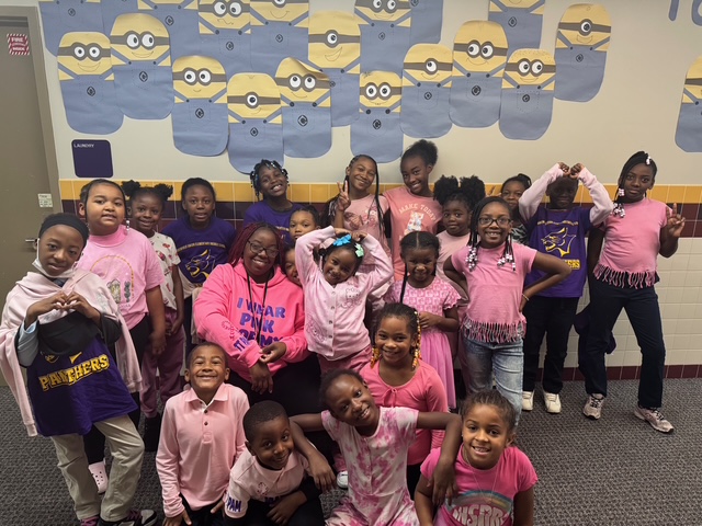  students wearing pink shirt for breast cancer 