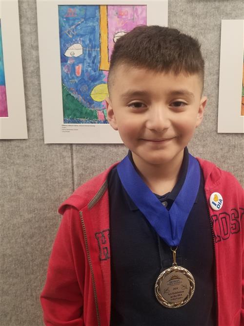 Anthony with award and artwork