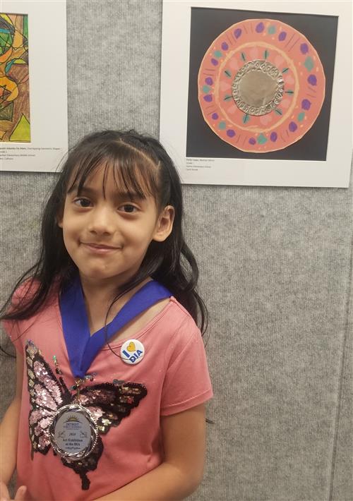 Emily with award and artwork