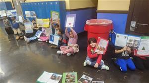 4th Grade Students holding up their amazing work ready to show it off to parents