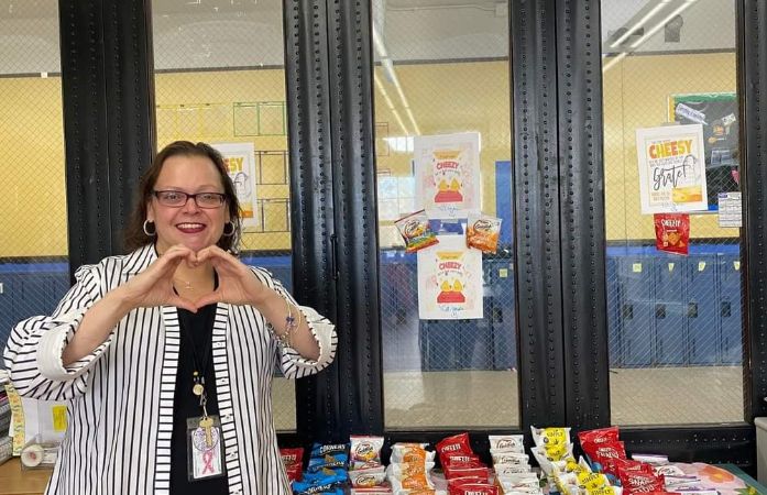  Principal Ramos making a heart with her hand to show appreciation for her staff