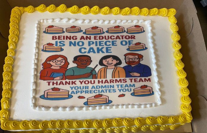A yellow and white cake for educators. 