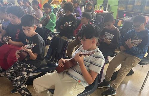  Students in music class playing the ukuleles