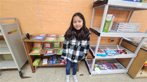 Young girl smiling while shopping at our PBIS Store 