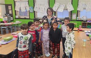  Kindergarten Teacher with her students wearing their pajamas in classroom