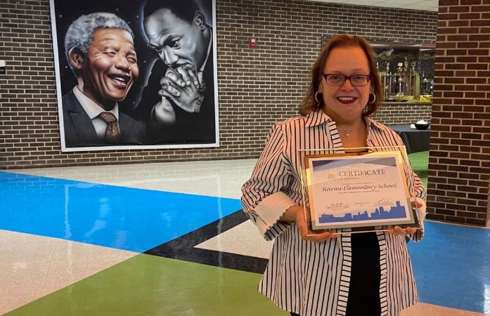  Principal Ramos proudly holding her certificate of recognition for improved attendance 