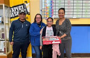 parent, Principal Ramos, pizza winner and Ms. Burch