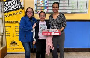  Principal Ramos and Attendance Agent, Ms. Burch posing with Ahmad, our Pizza winner for the week. 