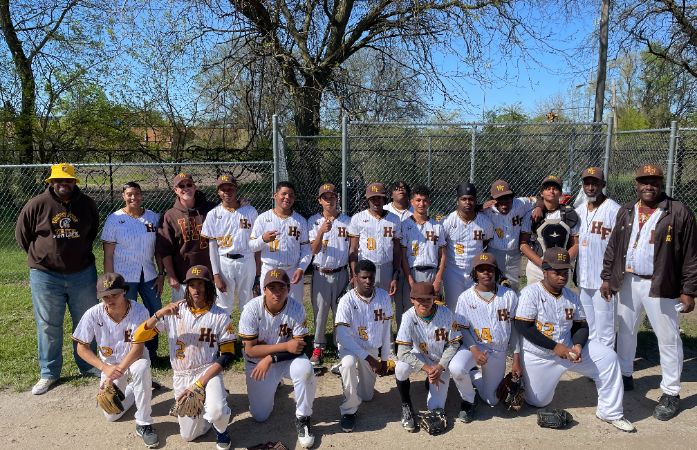  A group photo of the Henry Ford High School baseball team and coaching staff. The team is dressed i