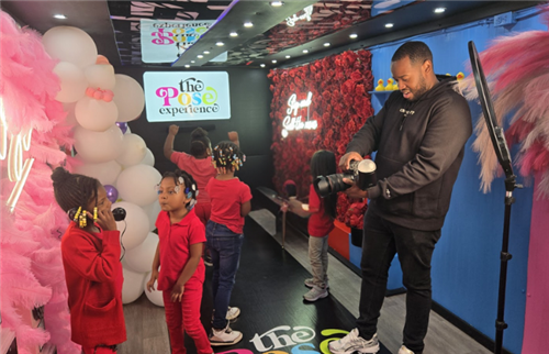  students in the selfie boutique posing for the photographer