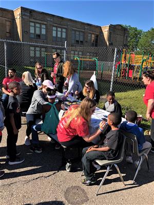 Students visiting the face painting table 