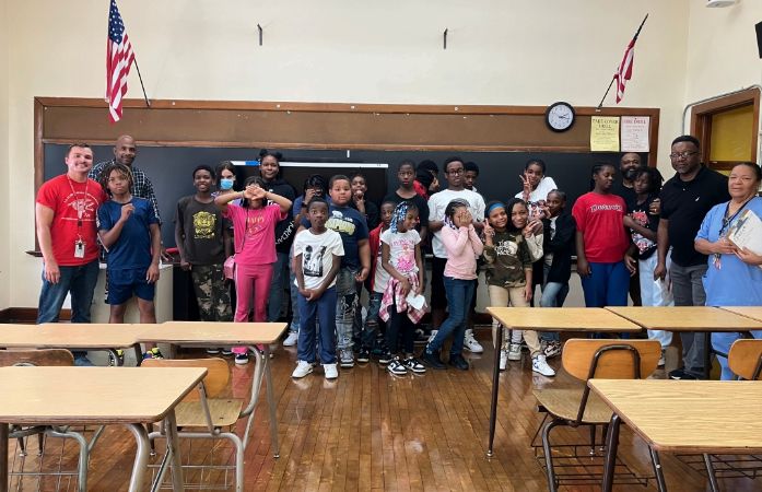 A group of Clark Students and staff members smiling for the camera
