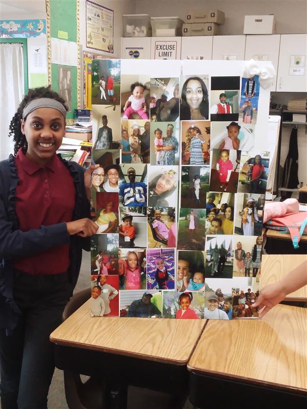 Student stands with her family history board.