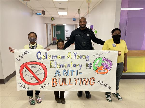 Paraders march with an anti-bullying banner