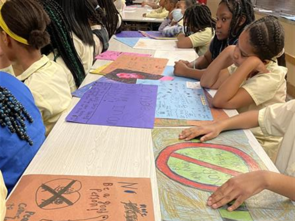 students display anti-bullying posters.