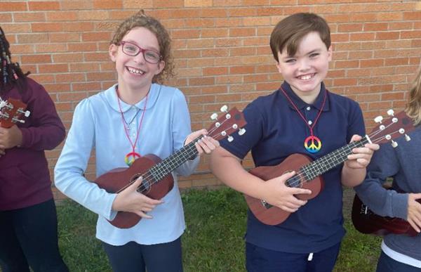 Learners playing their ukuleles.